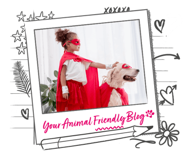 Image of a young girl and a dog, both wearing red hero masks and capes