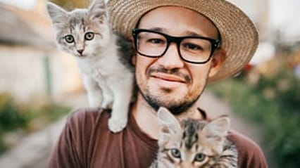 Cat sat on a man's shoulder
