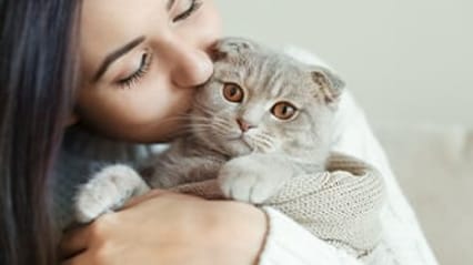 Lady cuddling a cat
