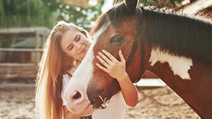 Horse being cared for by a lady