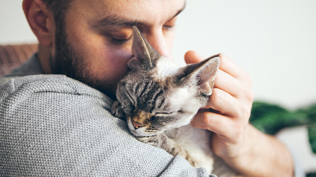 Image of a man holding a cat